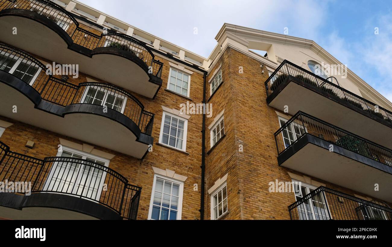 Exterior of modern yellow brick house. Architectural detail of close-up on windows, balconies ...