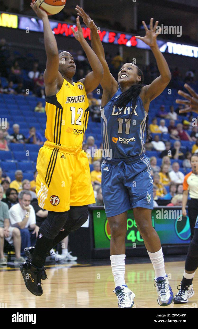 Tulsa Shocks Ivory Latta, left, shoots over Minnesota Lynxs Candice Wiggins during a WNBA basketball game in Tulsa, Okla., Saturday, June 9, 2012