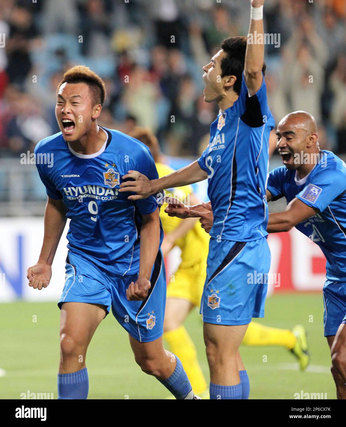 South Korean club Ulsan Hyundays Kim Shin-wook, left, celebrates with his  teammate Lee-ho and Julian Estiven Velez, right, after scoring a goal  against Japanese club Kashiwa Raysol during AFC Championship League soccer