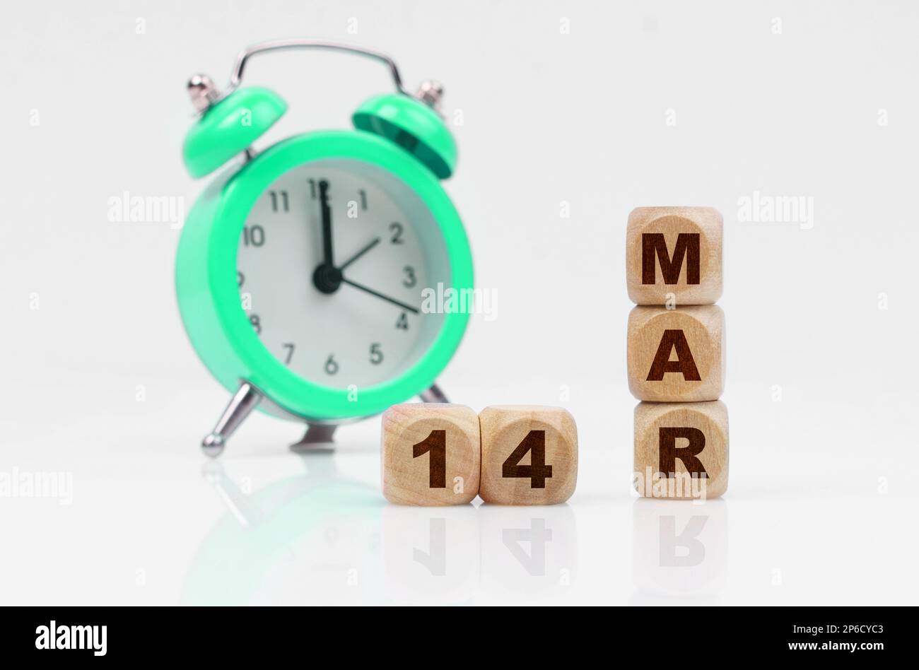 Business and holidays concept. On a white background, a green alarm ...