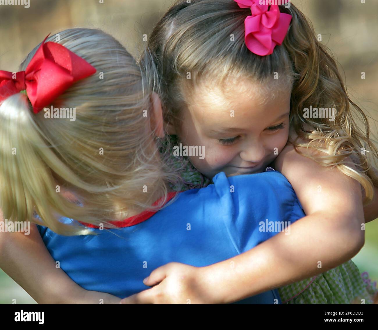 5-year-old Emma Urban hugs her K-4 classmate Sydney Bohac shortly after  communion on the playground to celebrate the last day of school at Trinity  Episcopal School in Victoria, Texas on Wednesday, May