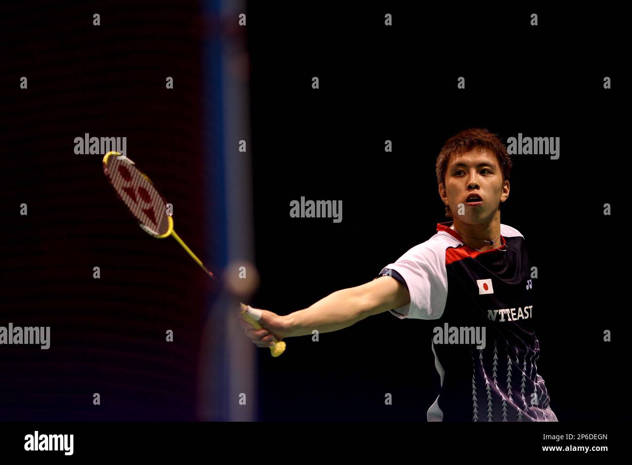 Kenichi Tago of Japan returns a shot to Taufik Hidayat of Indonesia during their mens singles match in the quarter-final round of the Thomas Cup badminton championship in Wuhan in central Chinas