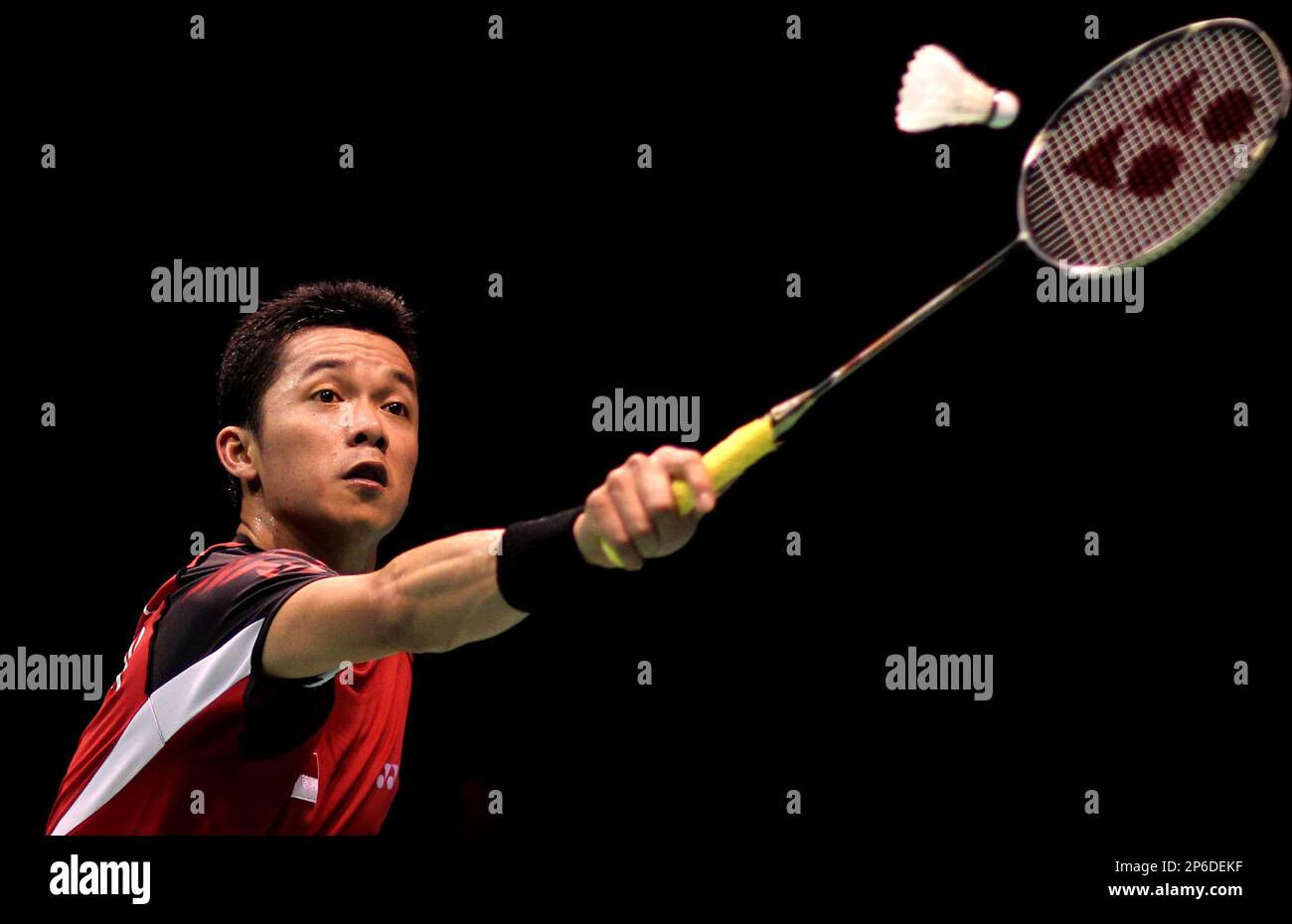 Taufik Hidayat of Indonesia returns a shot during a mens singles match against Kenichi Tago of Japan in the quarter-final round of the Thomas Cup badminton championship in Wuhan in central Chinas
