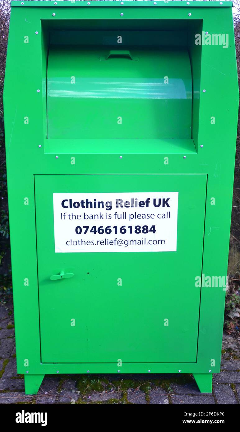 A clothing donation box with a sign from Clothing Relief UK on a street in Manchester, UK Stock Photo