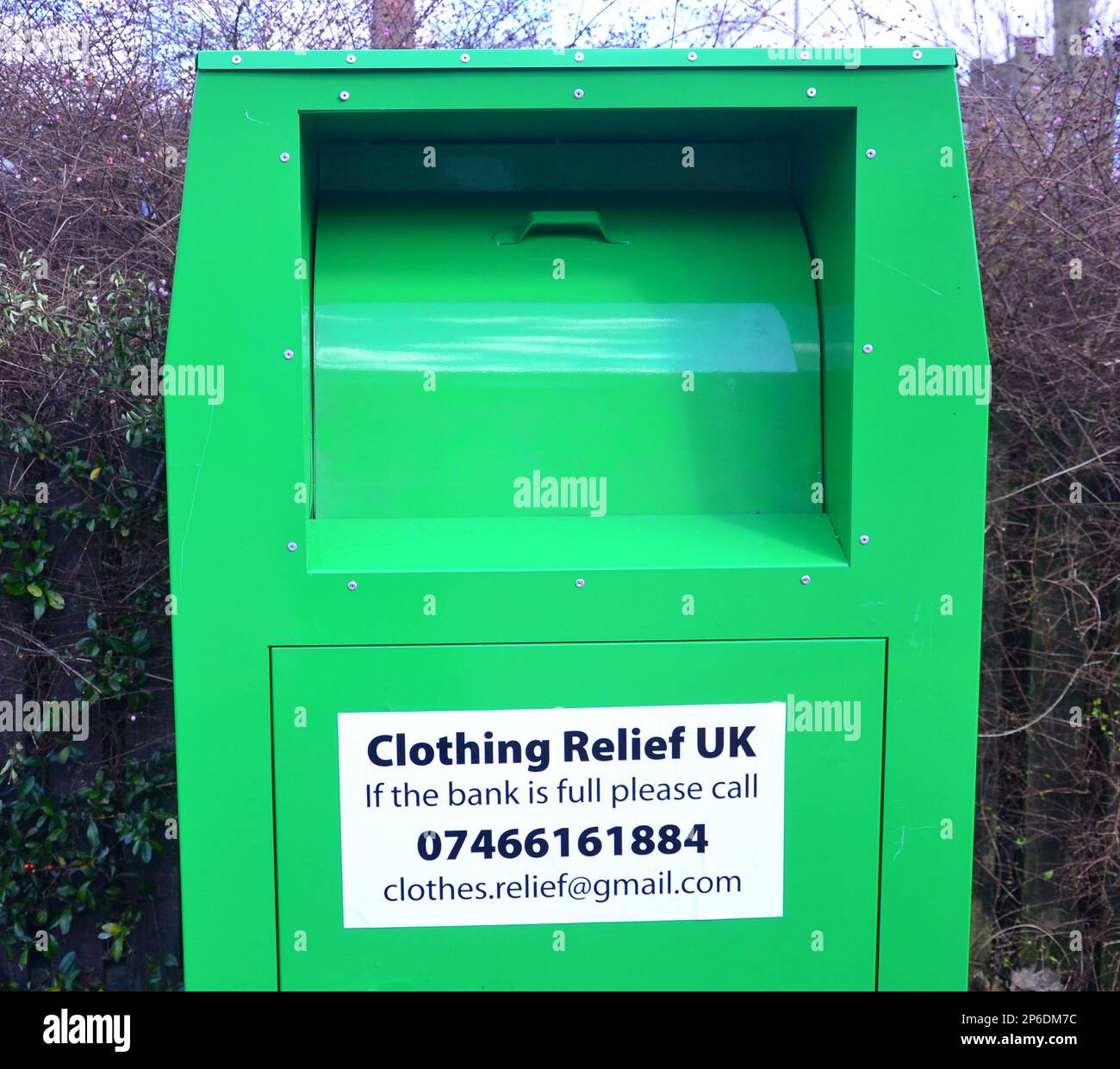 A clothing donation box with a sign from Clothing Relief UK on a street in Manchester, UK Stock Photo