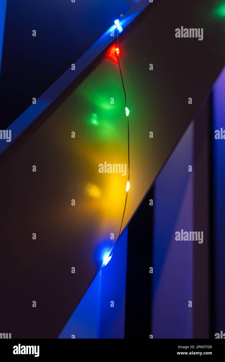 Colorful christmas lights hanging from a railing on stairs Stock Photo
