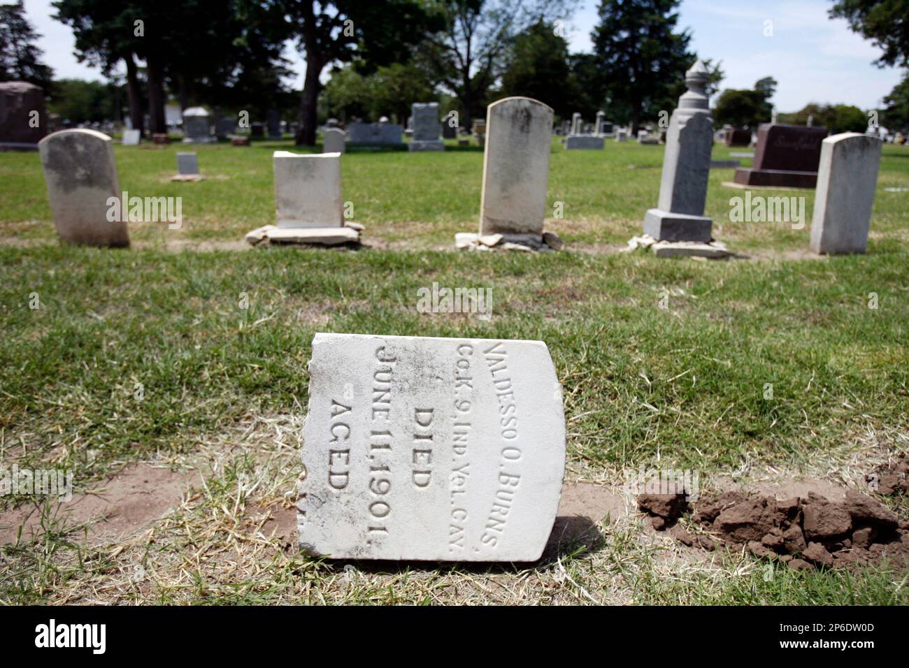 Vandalized headstones are seen Wednesday, May 17, 2012 at the at