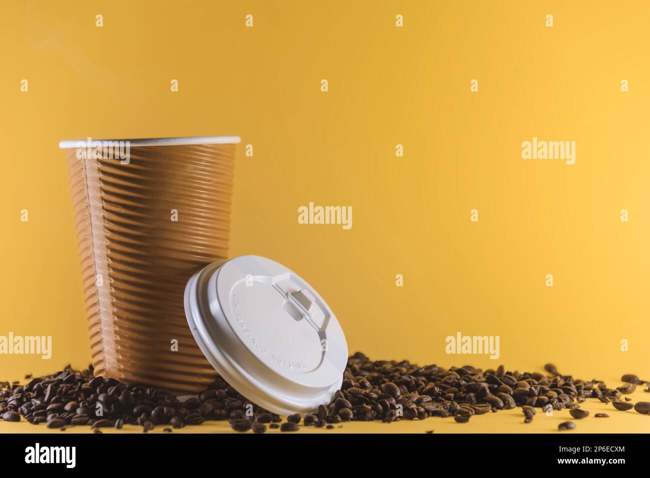Takeaway coffee cup on yellow background. Coffee container mockup