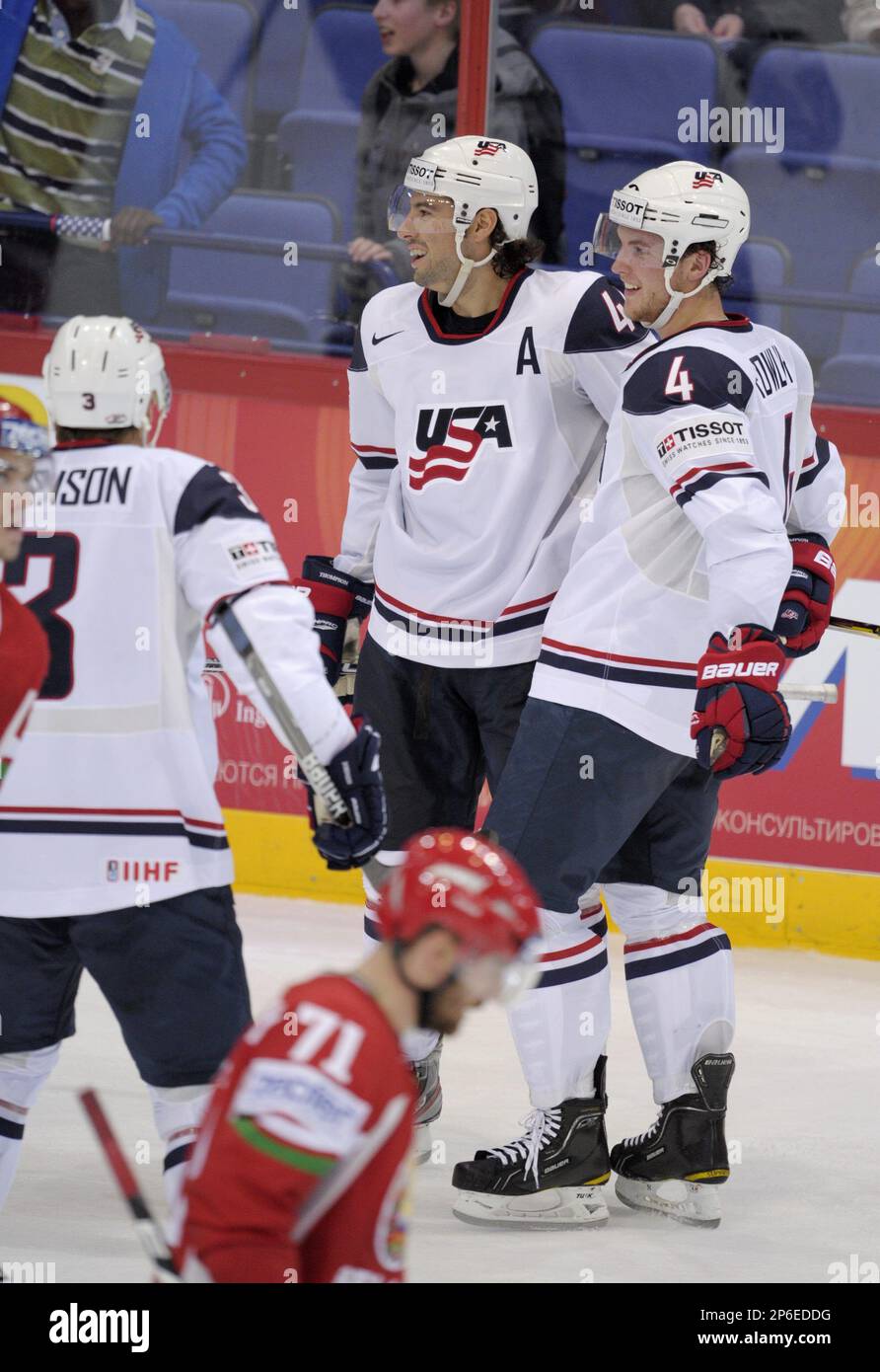 Alexei Kalyuzhny, front, of Belarus skates away as Jack Johnson, left, Nate  Thompson and Cam Fowler of the United States celebrate a goal during the  Group H game USA vs Belarus in