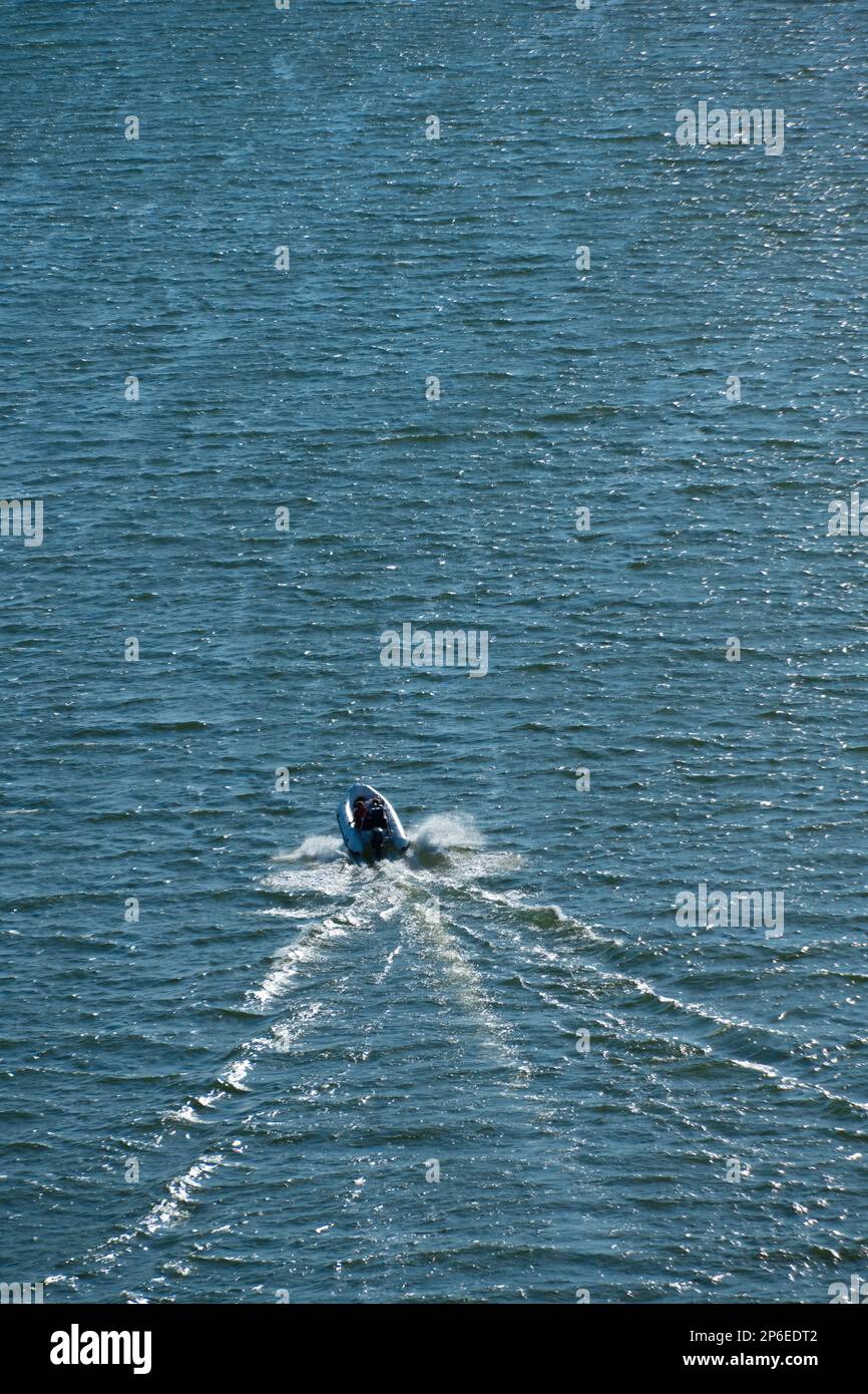 Small rib boat cruising on a fjord Stock Photo - Alamy