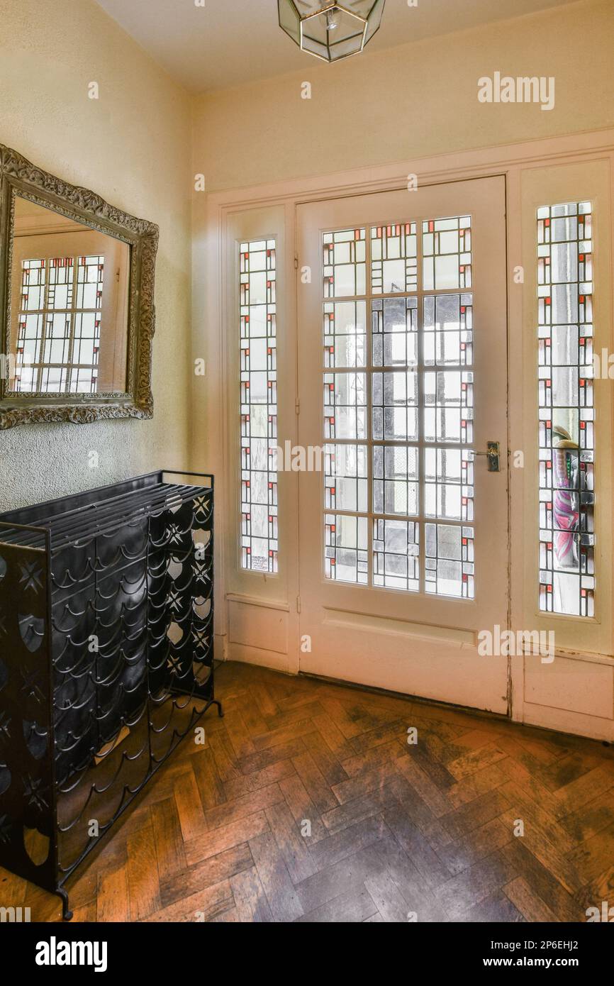 a living room with an antique dresser and large mirror on the wall in ...