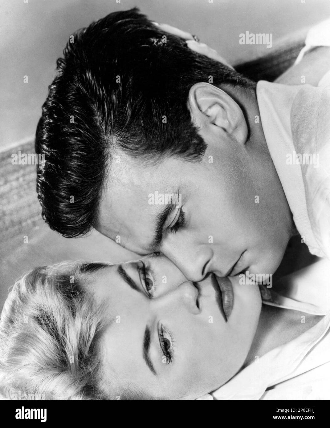 1956: The french actor  LOUIS JOURDAN ( born 19 June 1919 , Marseille,  France   )  and DORIS DAY ( real name Doris Mary Ann Kappelhoff , born 3 April 1924 Cincinnati, Ohio, USA ) in a scene from the triller movie  JULIE by Andrew L. Stone , MGM - COMEDY - FILM - CINEMA -  ----  Archivio GBB Stock Photo