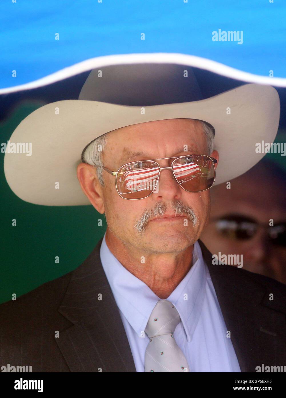 John Workman watches as his son Sgt. Chris Workman's casket is reflected in his glasses Friday