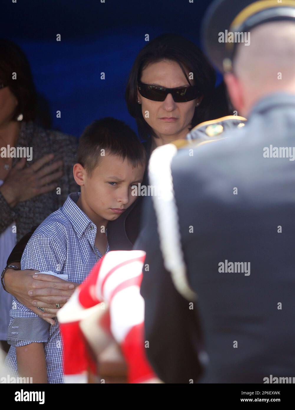 Widow Camille Workman and her son Cole Hayes look on during her late