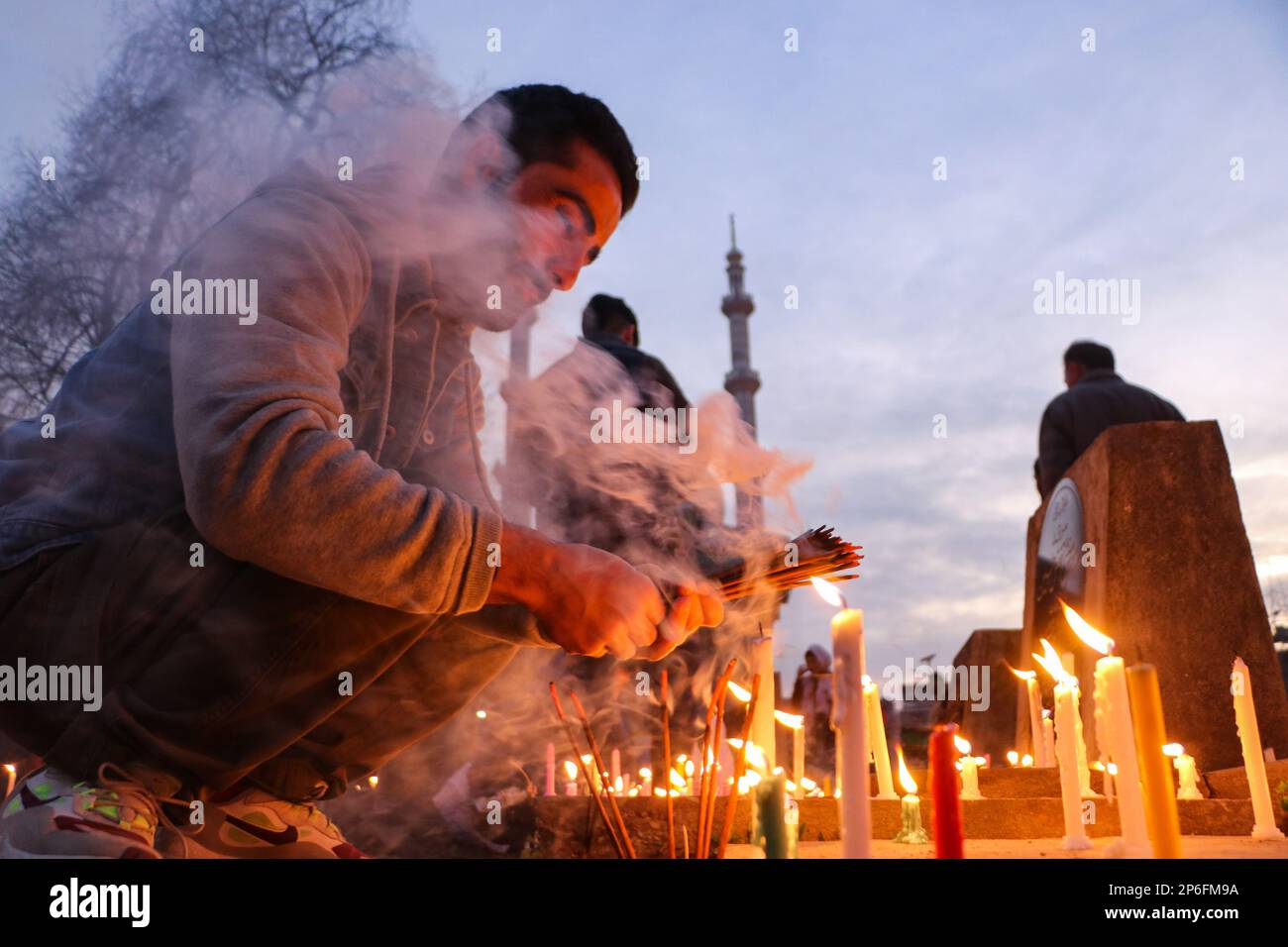 March 7, 2023, Srinagar, Jammu and Kashmir, India: A man lights candles ...