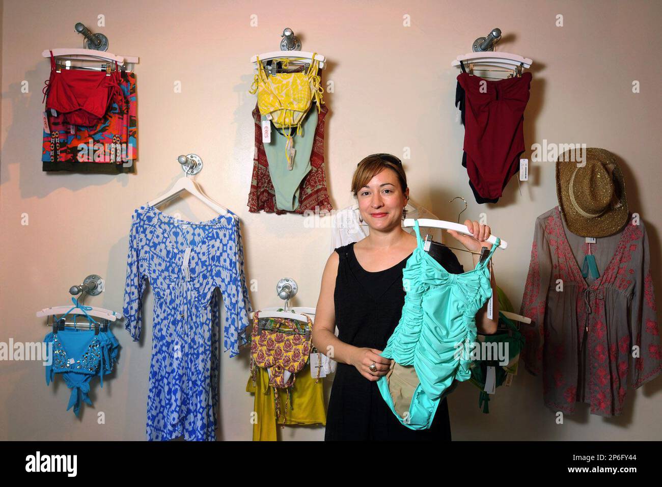 Stella Cortina Sardone, owner of Lilies & Lace at Lumina Statiob, dispalys  a selection of swim and beach wear Monday, April 16, 2012. (AP Photo/The  Star-News, Mike Spencer Stock Photo - Alamy