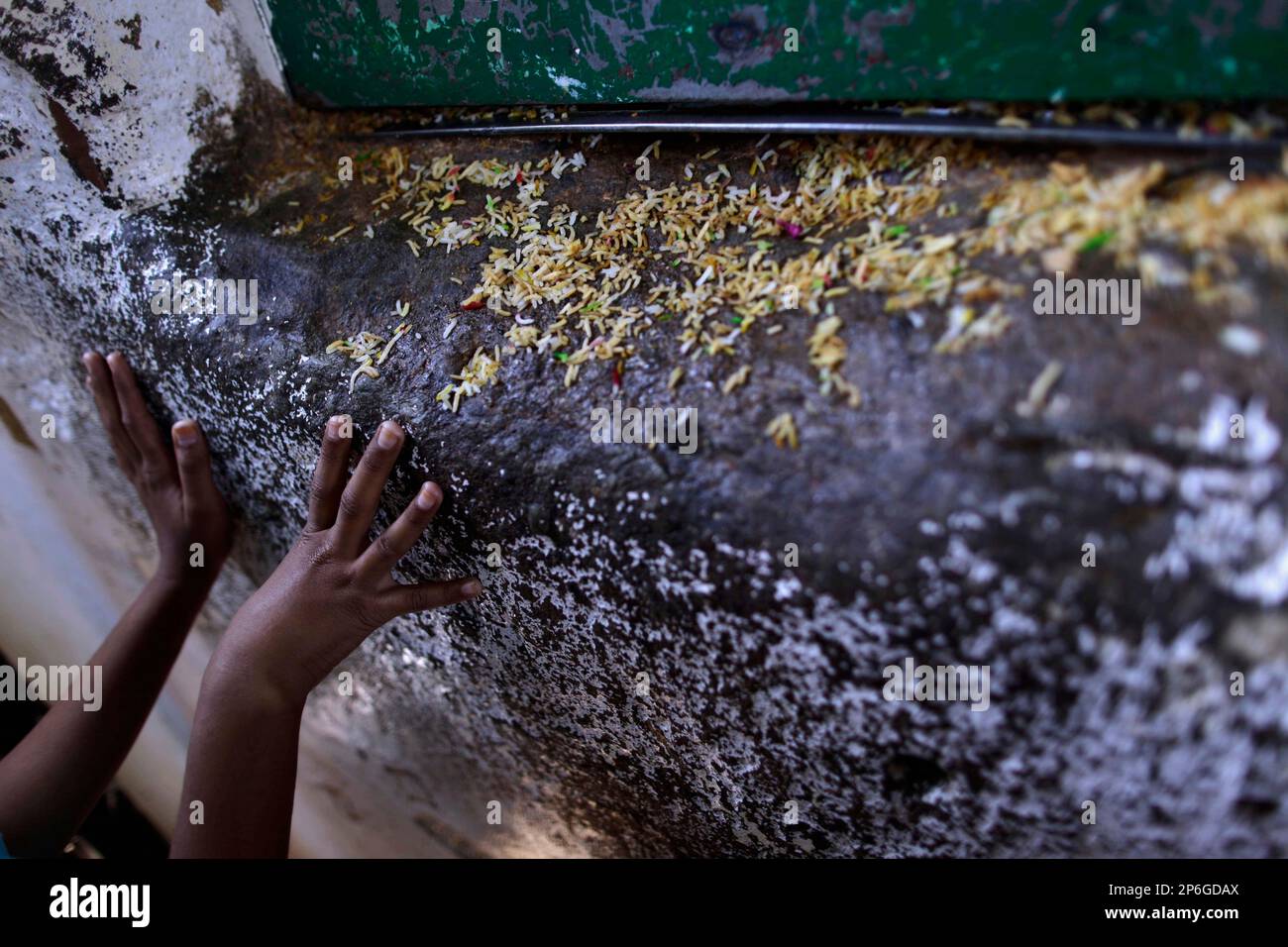 Imam Rice A Pakistani girl, waits by the window where rice is distributed, during ...