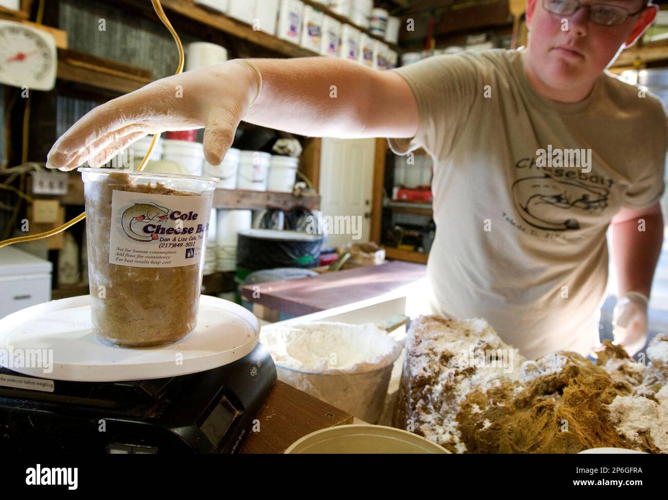 ADVANCE FOR USE SUNDAY, APRIL 15 AND THEREAFTER - In this photo taken April  5, 2012, Colin Cole, 15, weighs a container of hand-made catfish bait at  family's 500-acre farm in the