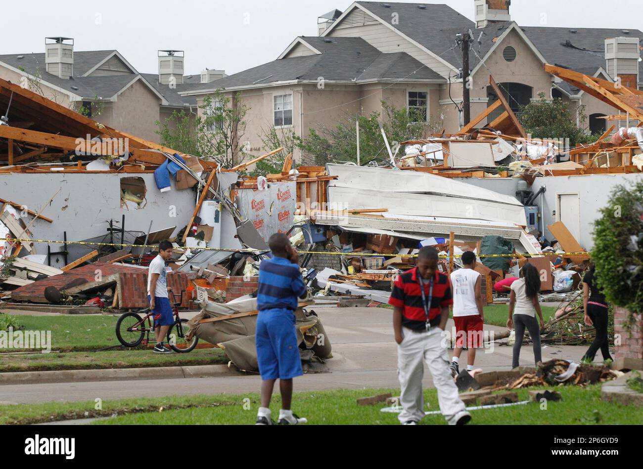 Neighbors view what remains of a home in Arlington, Texas, Tuesday ...