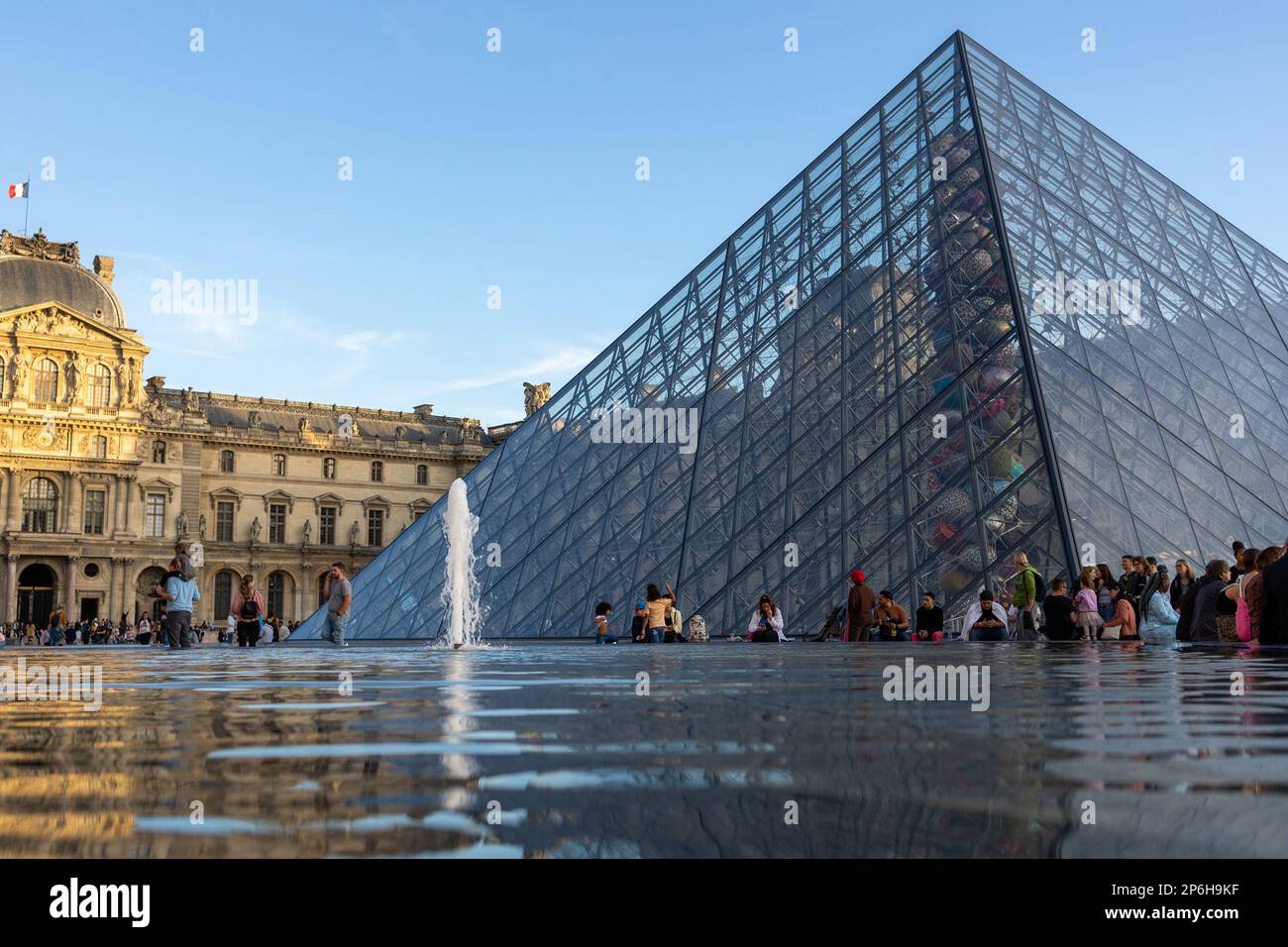 Louvre Museum. Tourists walk on the square of the Louver Museum Stock ...