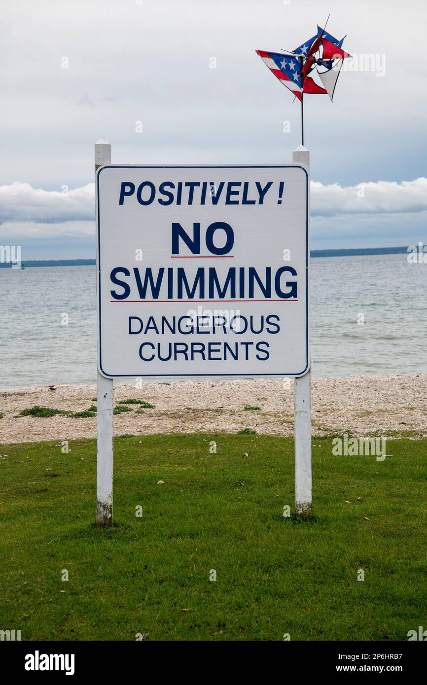 Mackinac Island, Michigan. No swimming sign on the beach looking at