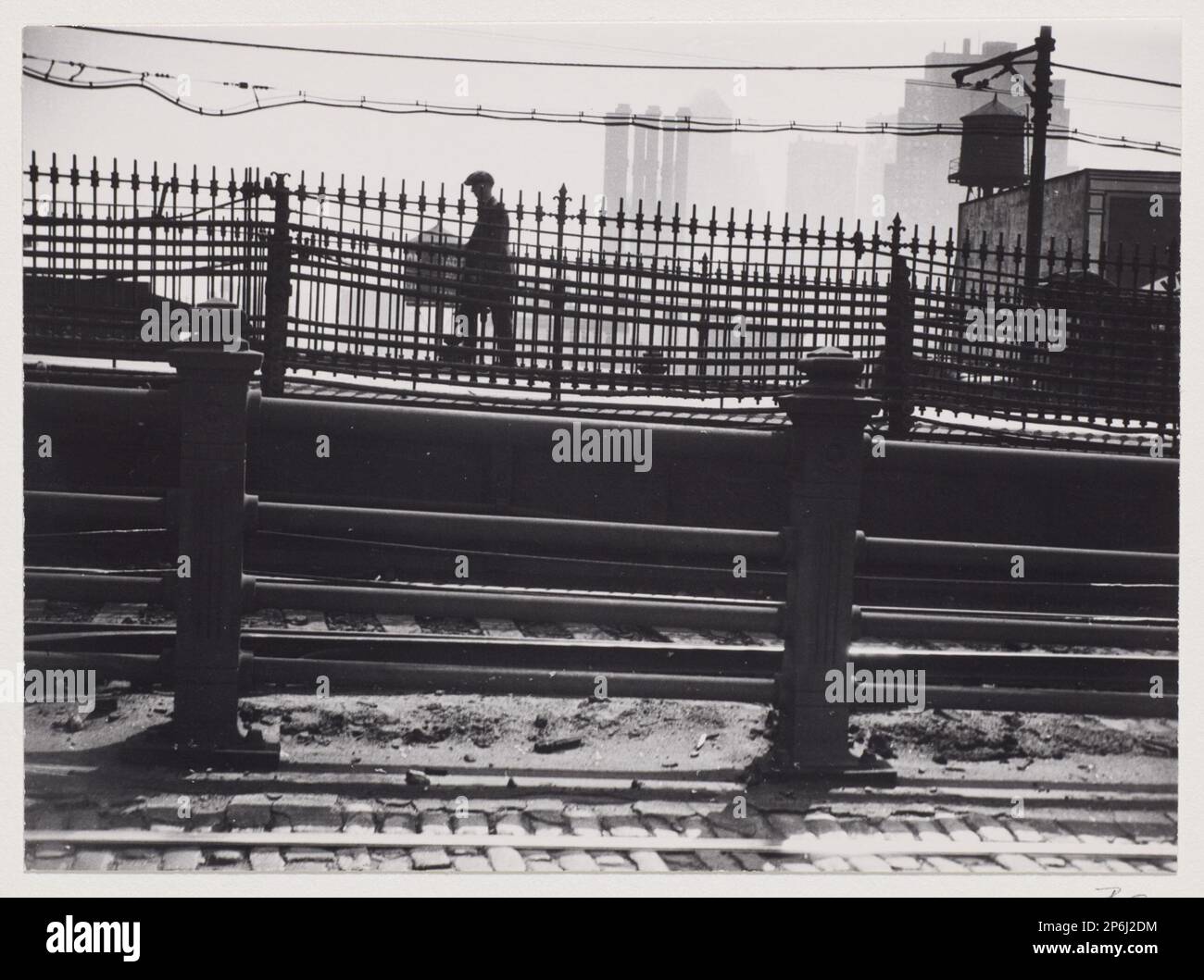 Berenice Abbott, Man on Brooklyn Bridge, New York , 1929–1931, printed 1982, gelatin silver print. Stock Photo