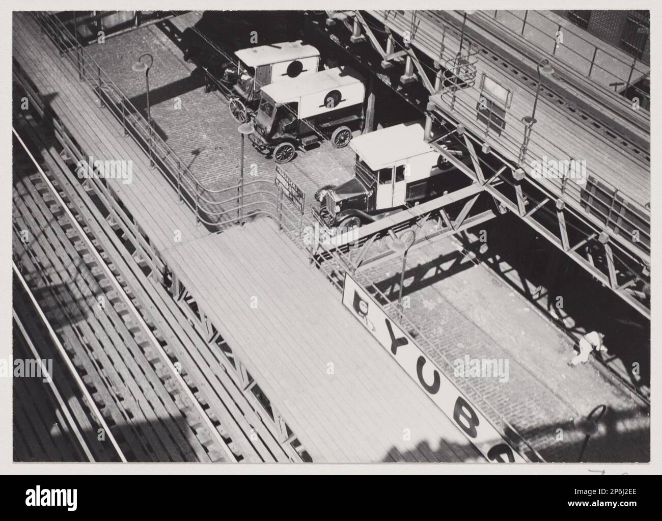 Berenice Abbott, Untitled [Delivery trucks under the Second Avenue Elevated, New York] , 1929–1931, printed 1982, gelatin silver print. Stock Photo