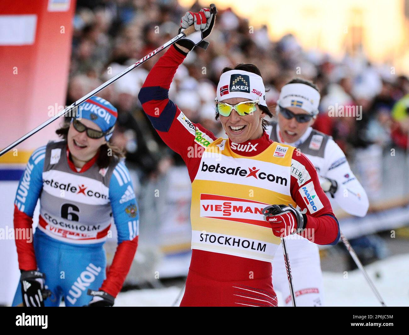 Norways Marit Borgen, center, celebrates her victory as Russias Julia Ivanova, left, placed second, during the FIS Cross-Country World Cup 1,0km classic sprint final in Stockholm, Wednesday March 14, 2012