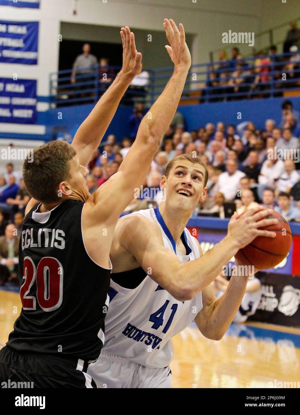 Florida Tech 's Edgars Eglitis, left, defends as Alabama Huntsville's