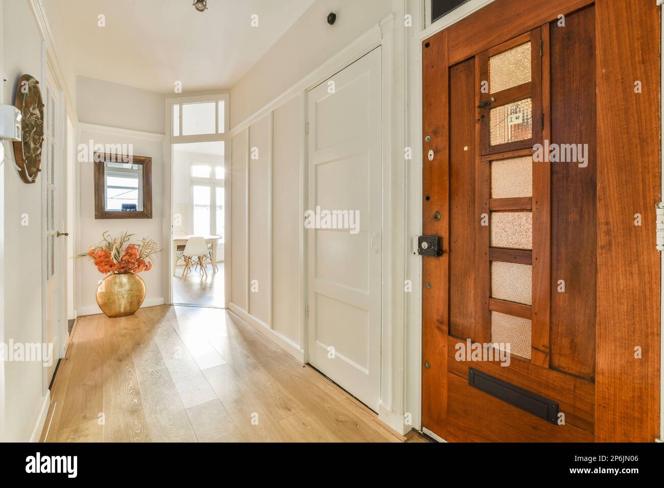 an entry way with wood floors and white trim on the door, and wooden ...