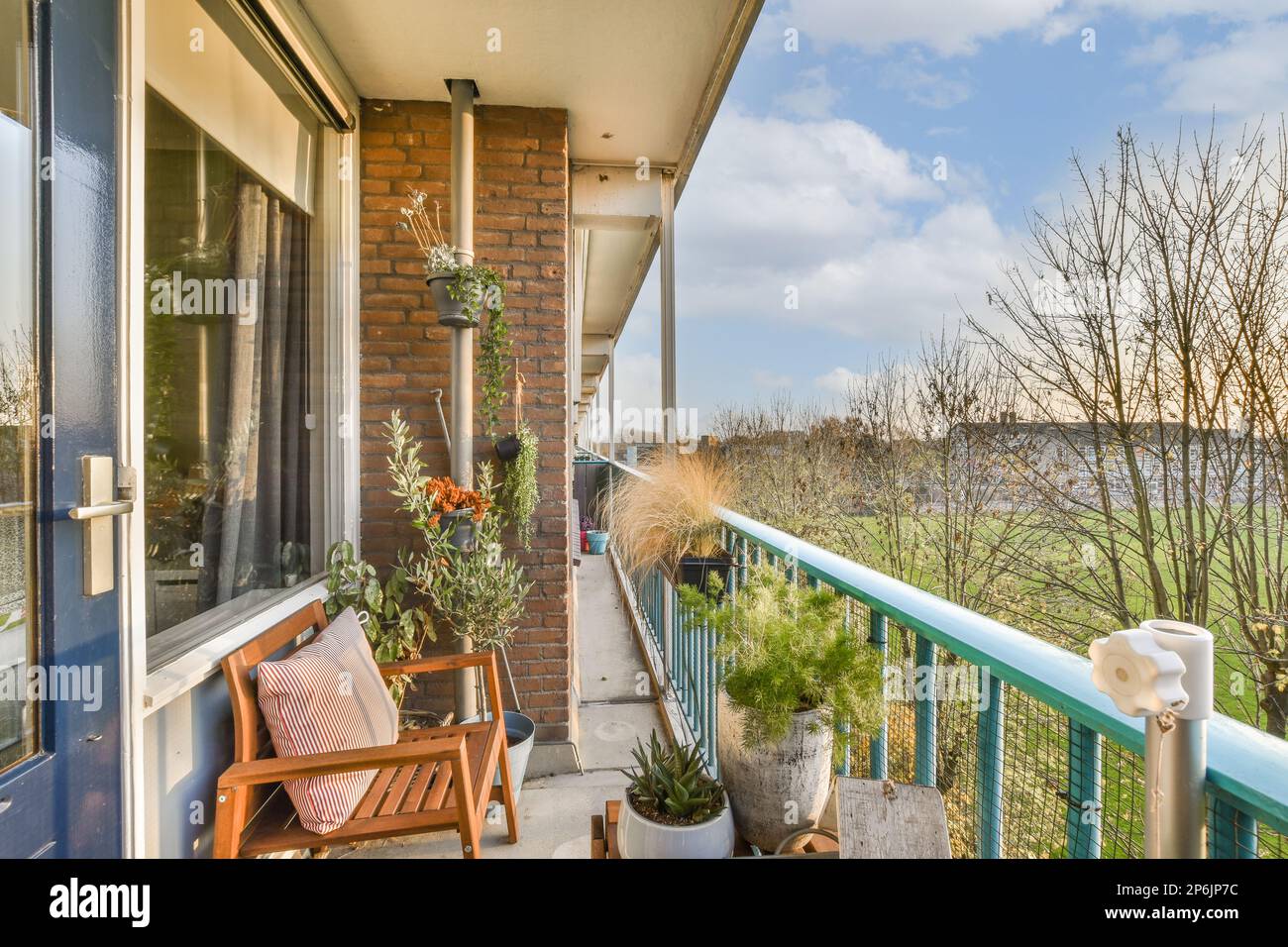 a balcony with chairs and plants on the front porch, looking out onto the water from an apartment in new york Stock Photo