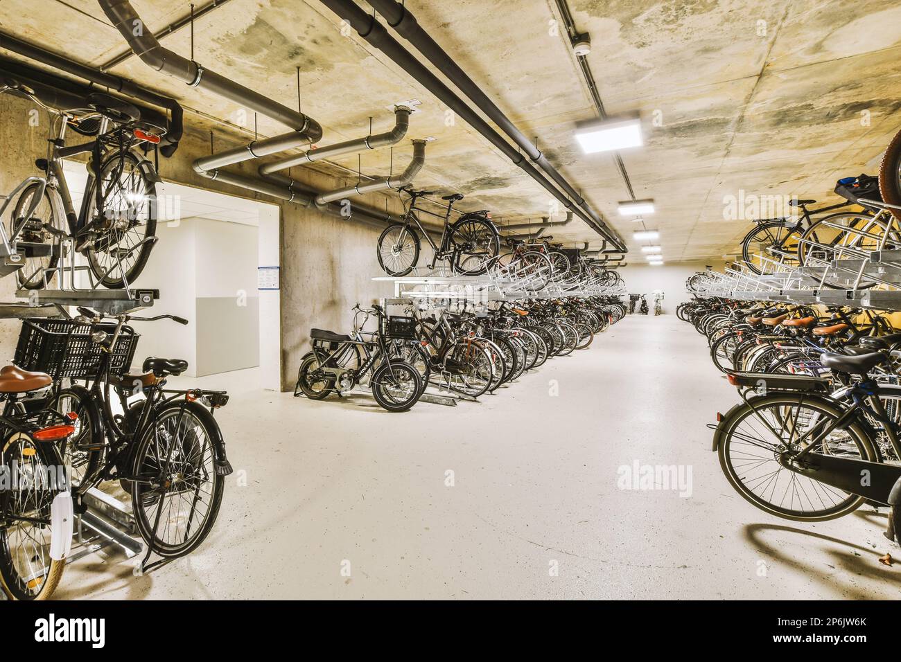 some bikes parked in a parking garage with no one on the bike racked up