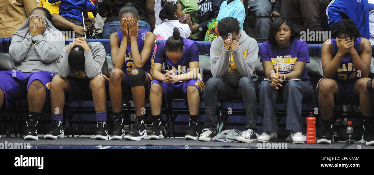 Hattiesburg basketball team members show their disappointment and heartbreak as time runs out