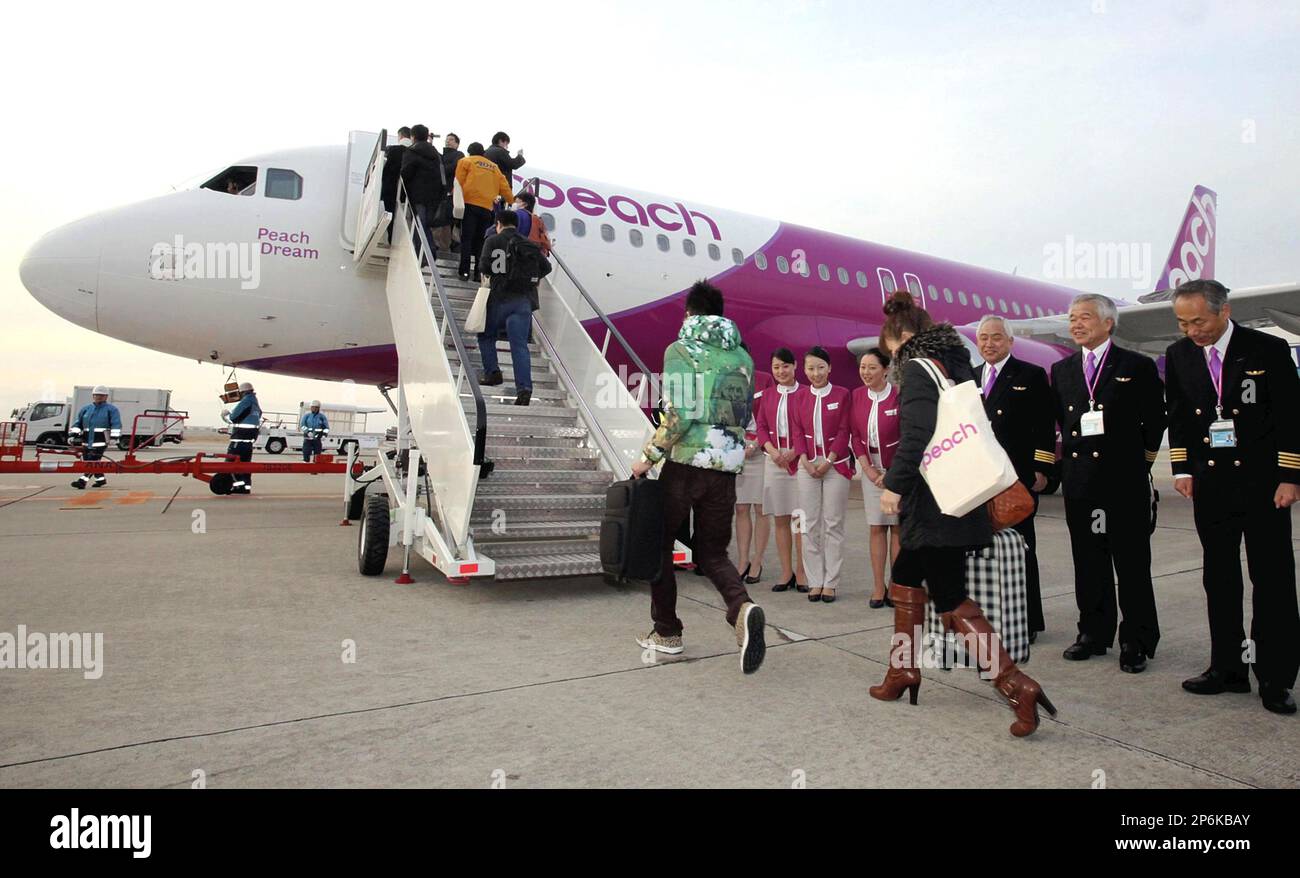 Passengers get on board the first flight of Peach Aviation, Japanese lowcost carrier, which