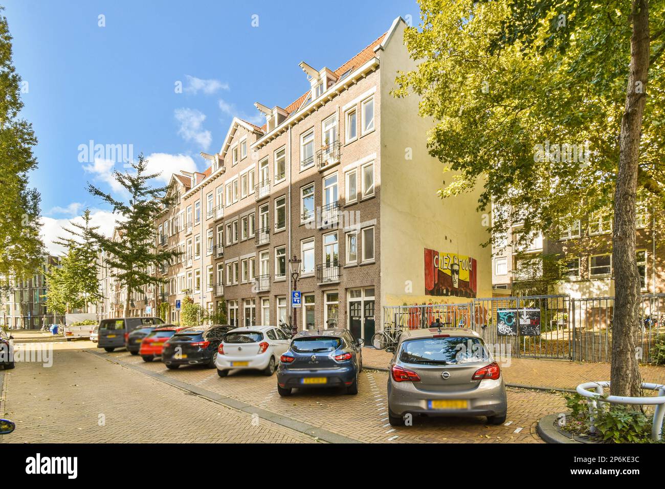 some cars parked on the side of a street in front of buildings with ...