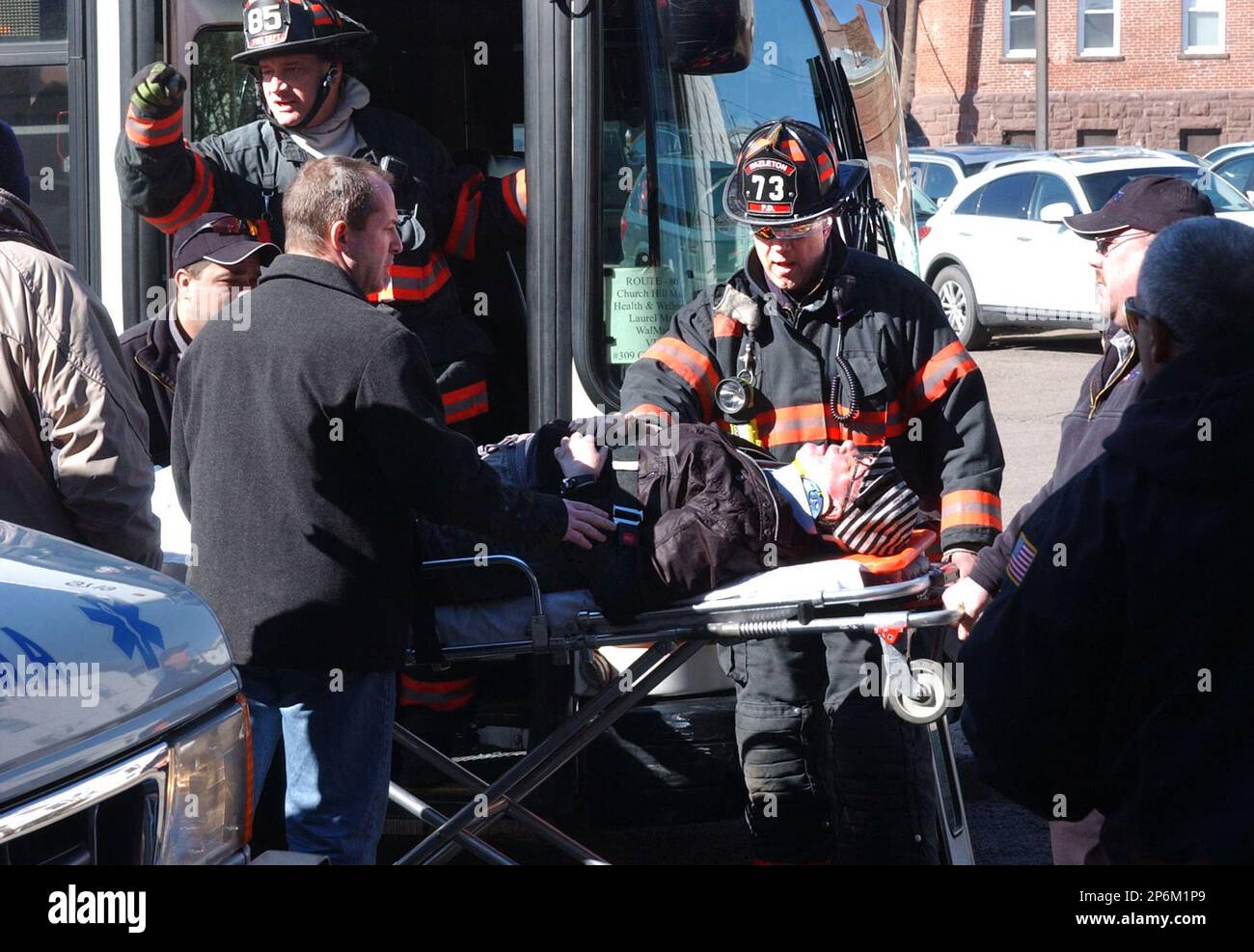 Hazleton emergency personnel carry one of several bus passengers to an