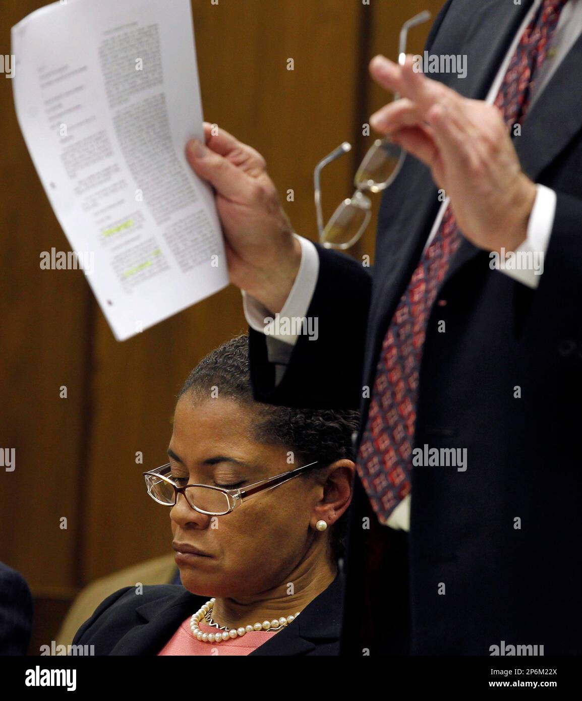 Suspended District Attorney Tracey Cline, left, looks at notes as her