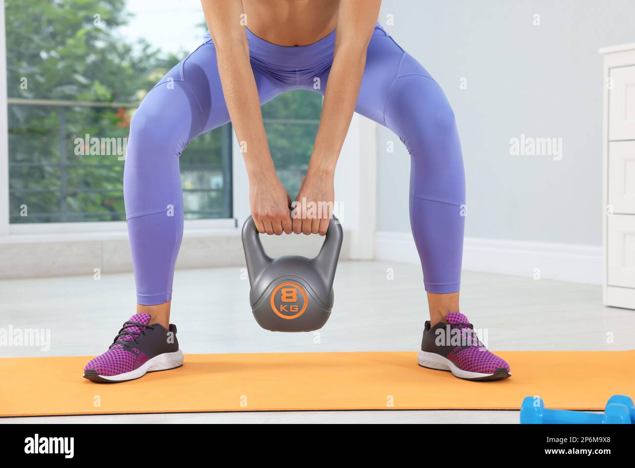 training with kettlebell at home, Photo - Alamy