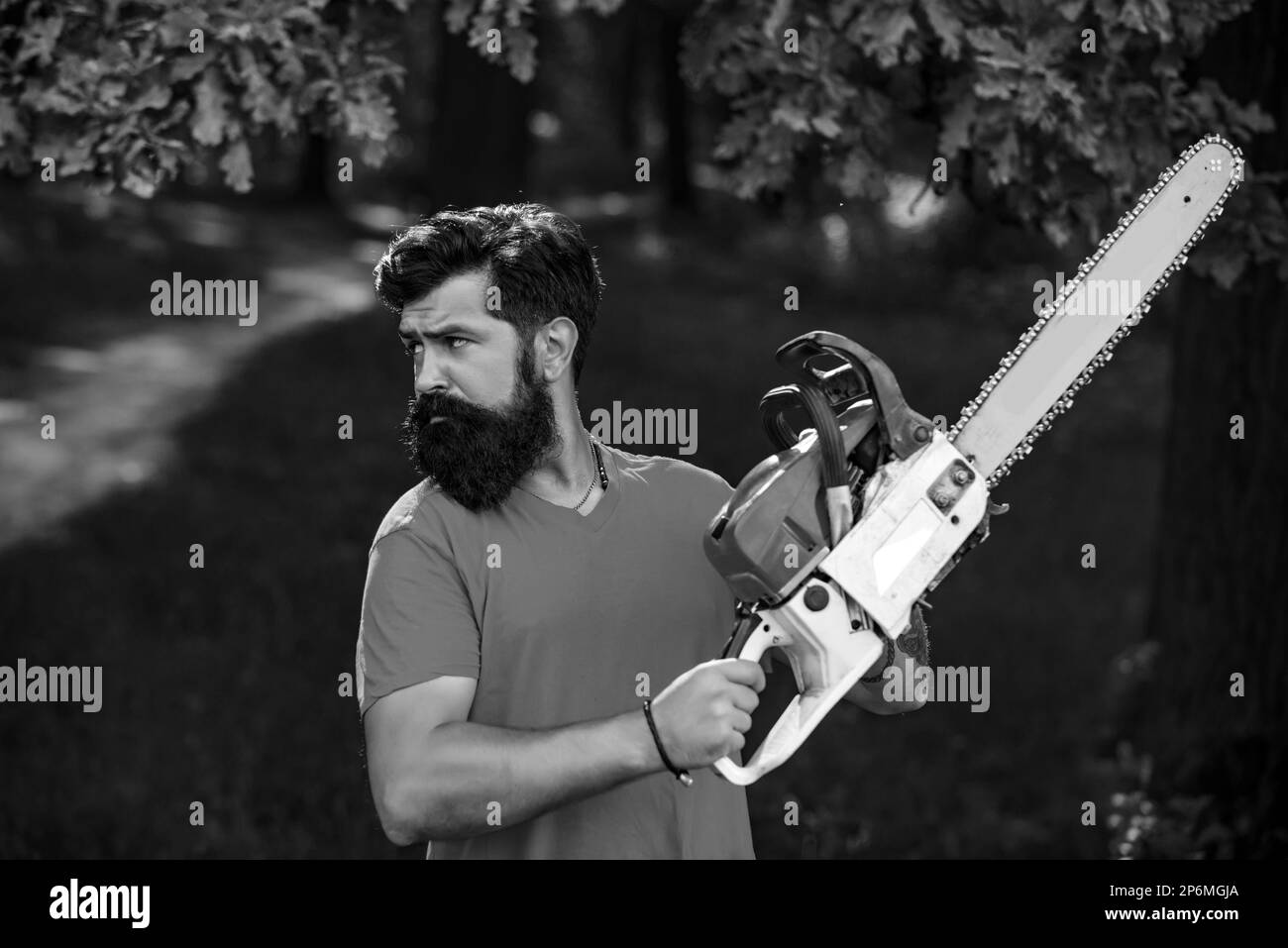Deforestation. Man doing mans job. Lumberjack worker with chainsaw in