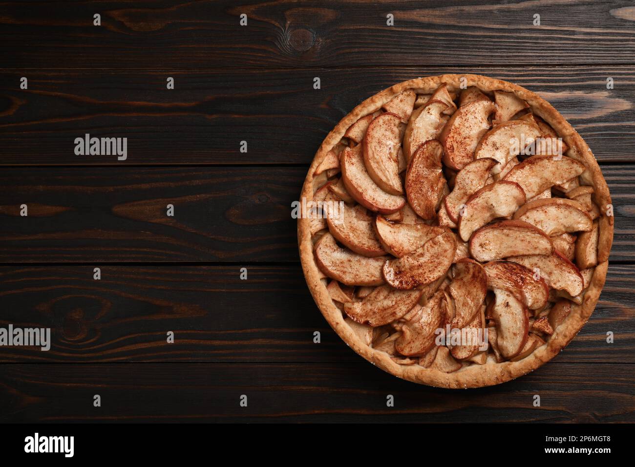 Delicious apple pie on wooden table, top view. Space for text Stock Photo