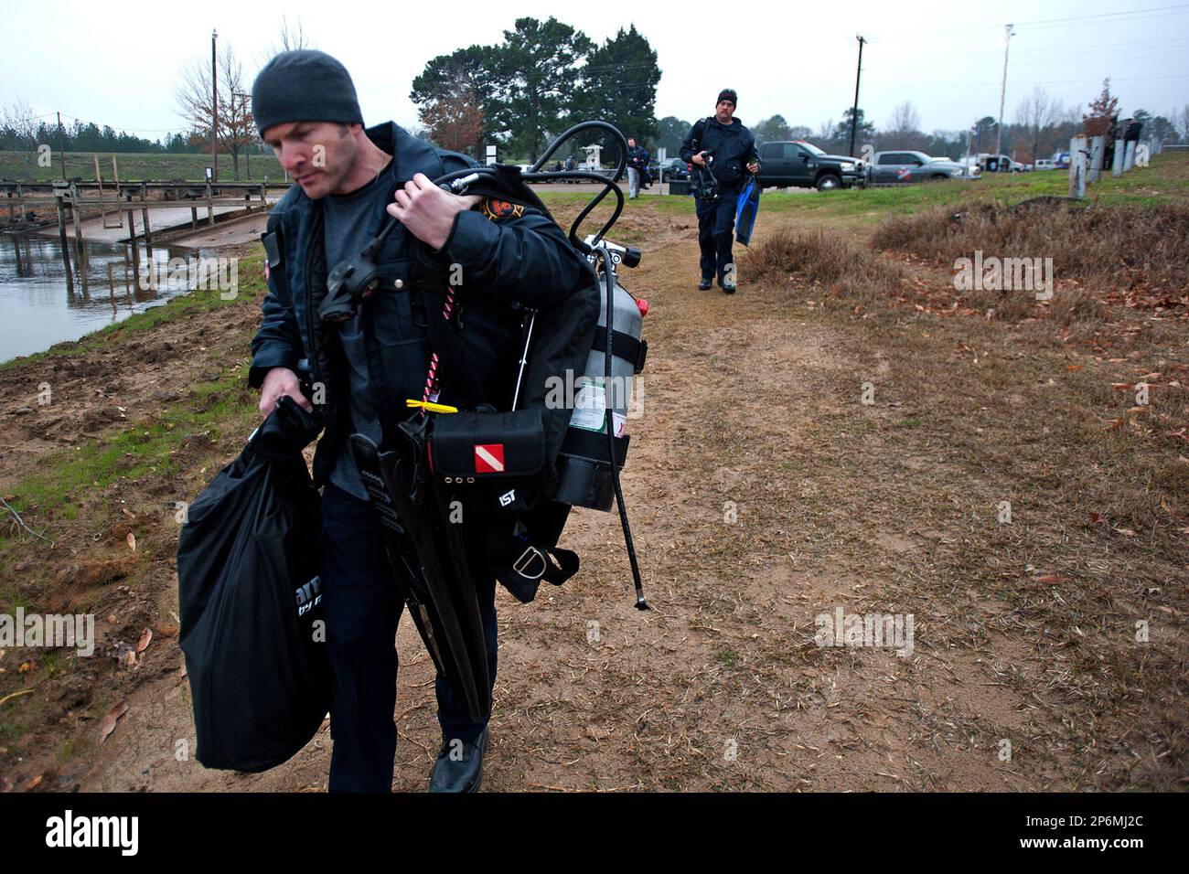 Recovery divers carry their gear to the barge they will use to recover