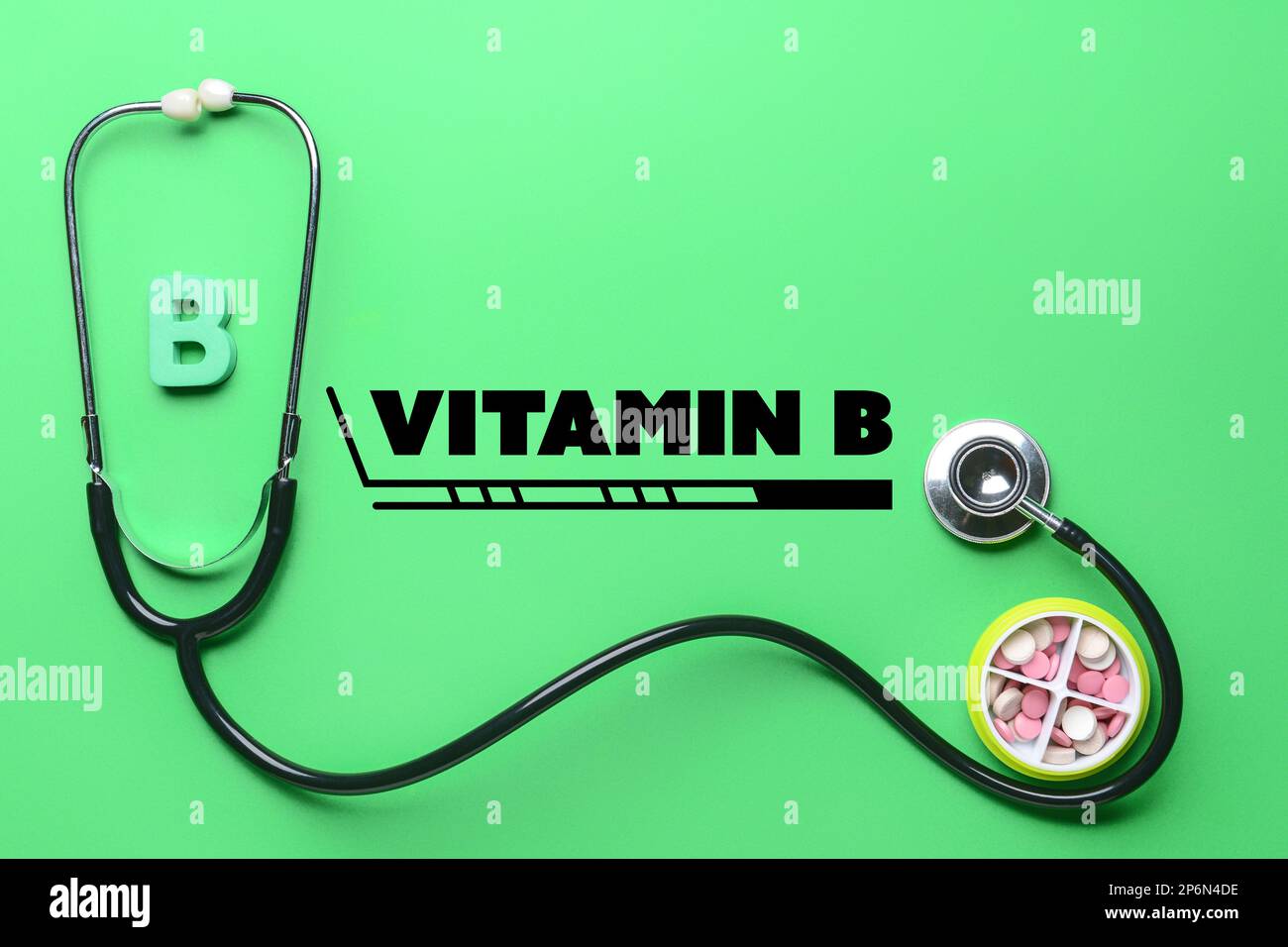 Letter B with stethoscope and pills on green background Stock Photo