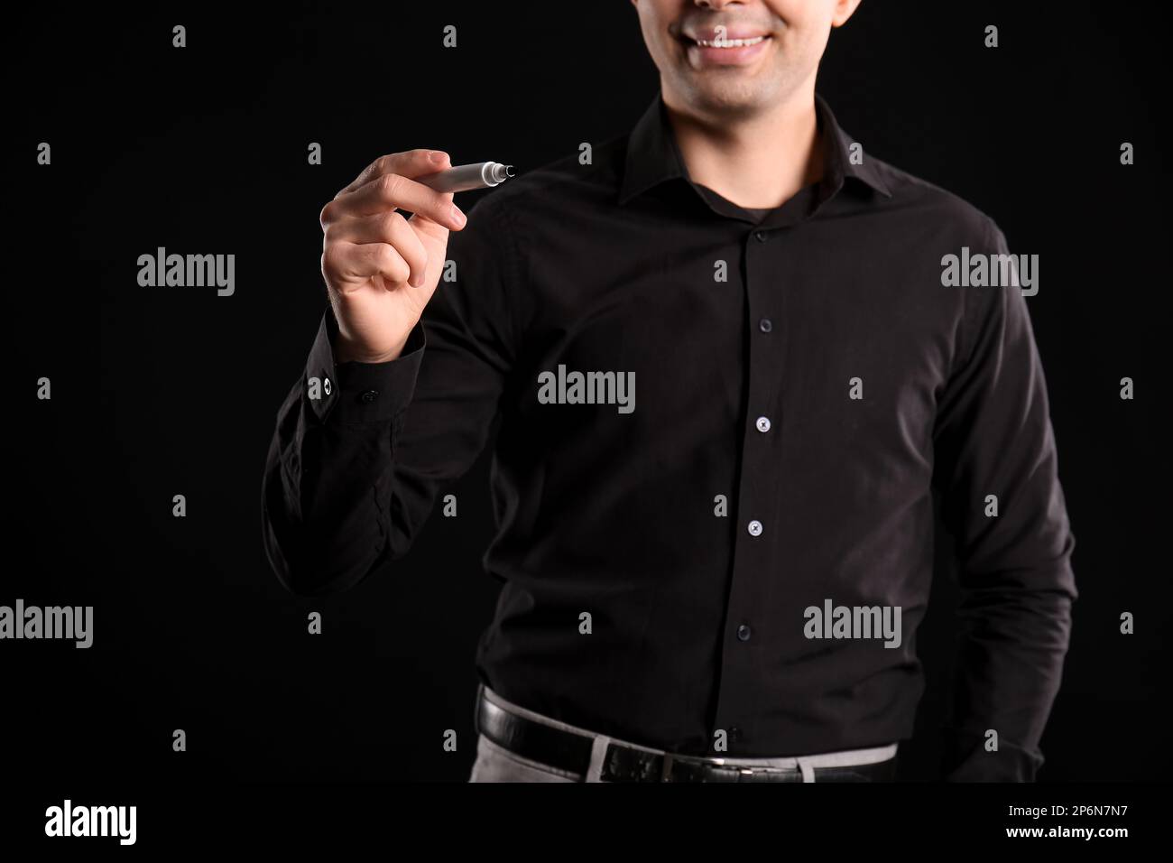 Business consultant with marker using virtual screen on dark background, closeup Stock Photo