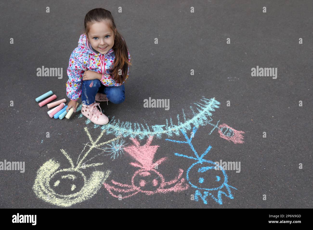 Child drawing family with chalk on asphalt Stock Photo - Alamy