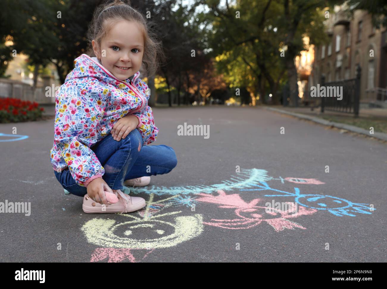 Child drawing family with chalk on asphalt Stock Photo - Alamy