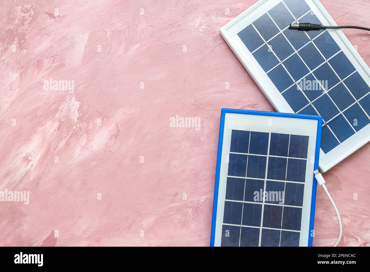 Portable solar panels with cables on pink grunge background Stock Photo ...