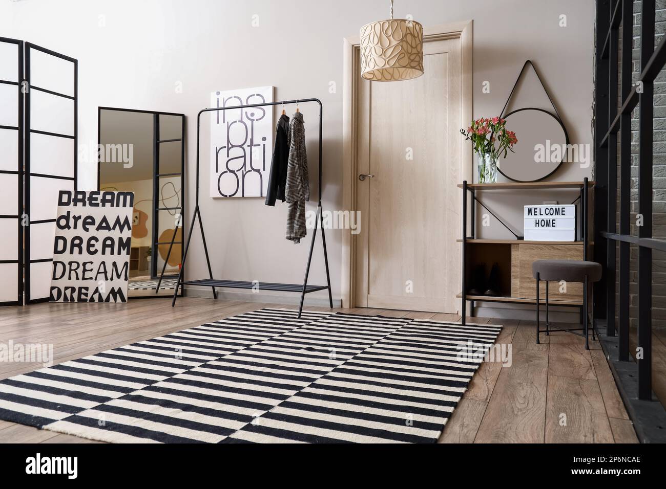 Interior of modern hall with rack, mirrors and door Stock Photo - Alamy