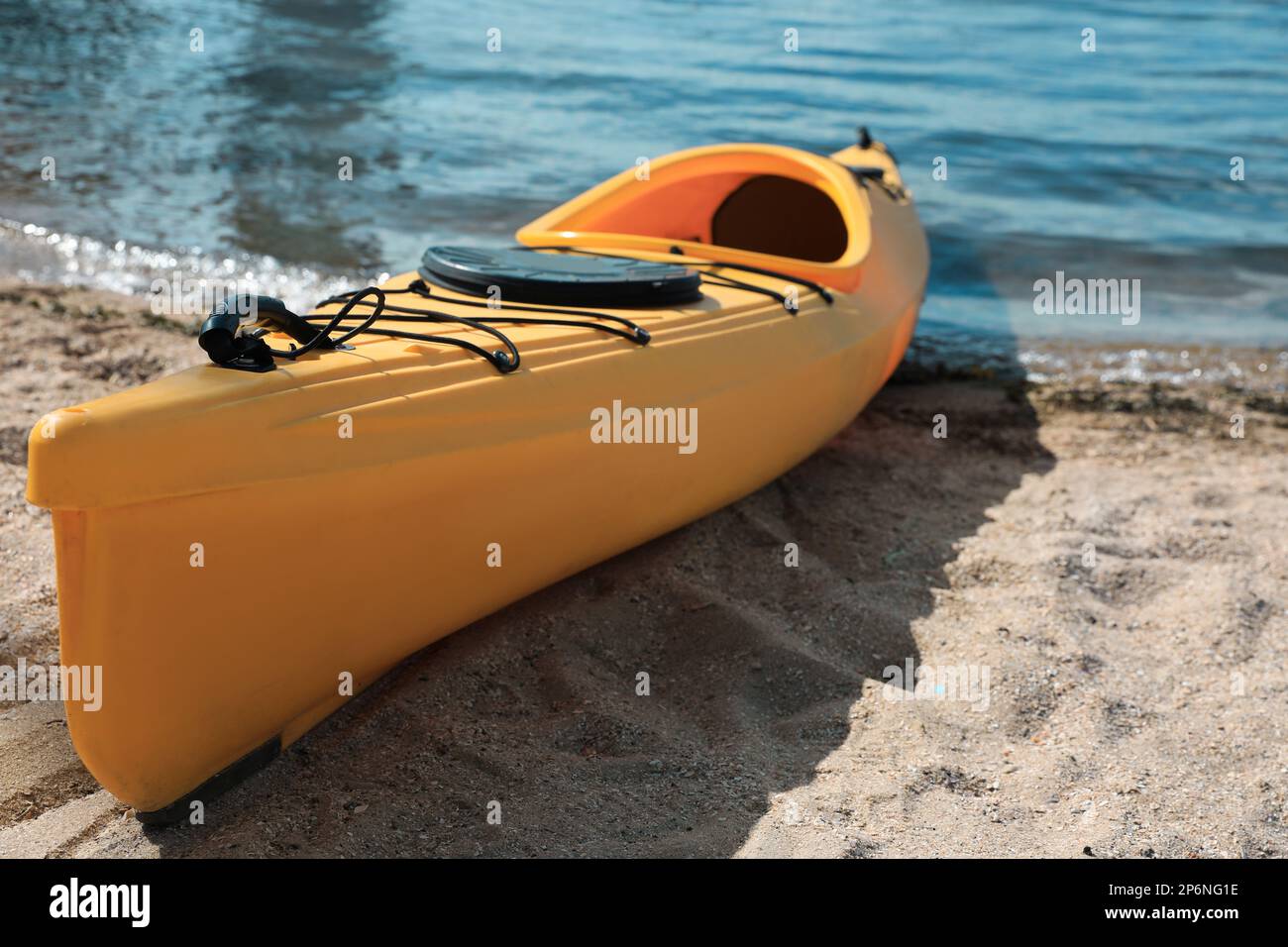 Yellow kayak on beach near river. Summer camp activity Stock Photo - Alamy