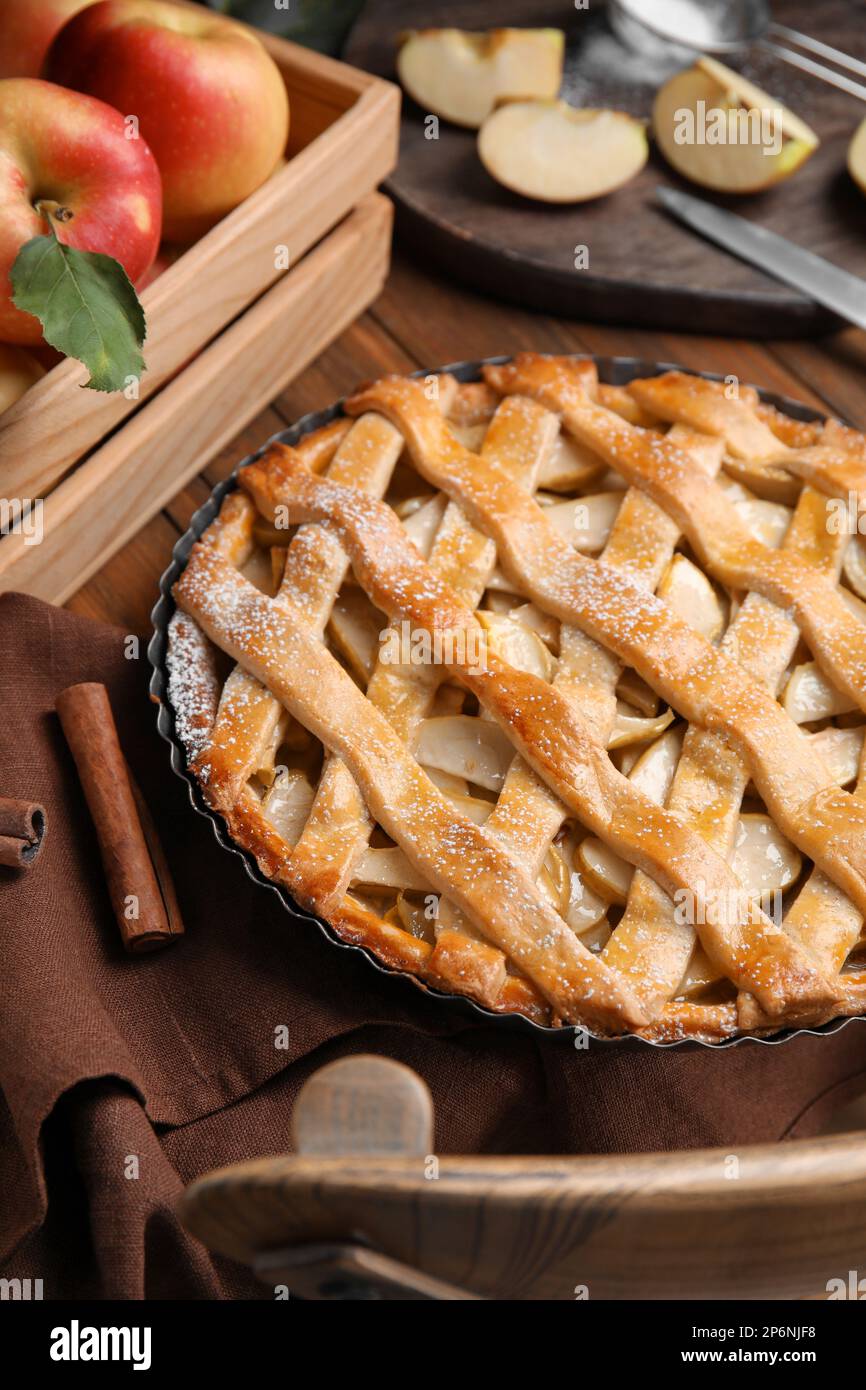Delicious traditional apple pie on wooden table Stock Photo