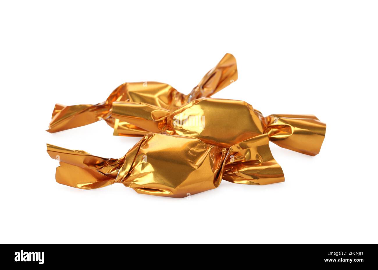 Delicious candies in golden wrappers on white background Stock Photo